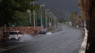 Tropical Storm Ernesto nears hurricane strength as it skirts Puerto Rico, bringing power outages and potential flooding